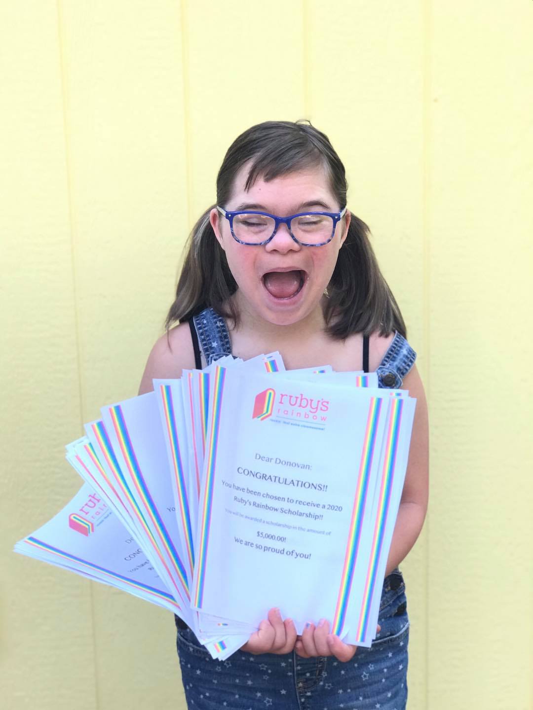Ruby Doobs holds the 2020 Rockin' Recipients scholarship letters