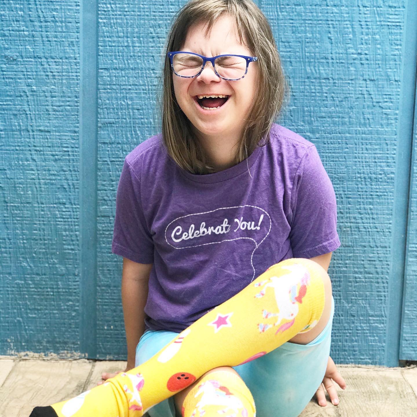 Ruby Doobs smiling as she sports her special edition "Celebrate YOU!" socks she created with Pride Socks!!